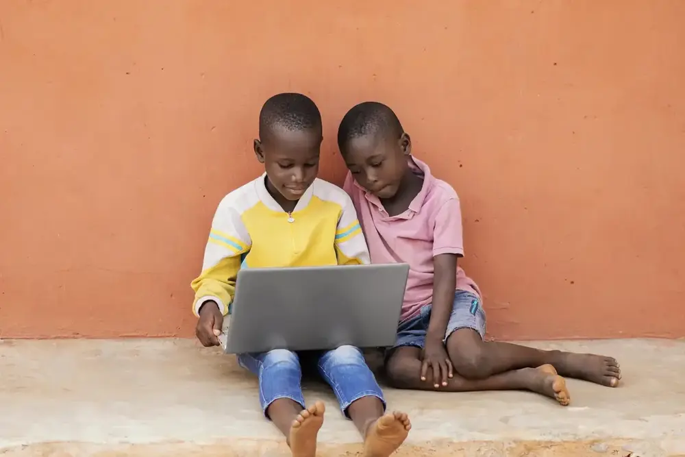 Kids learning programming with a laptop